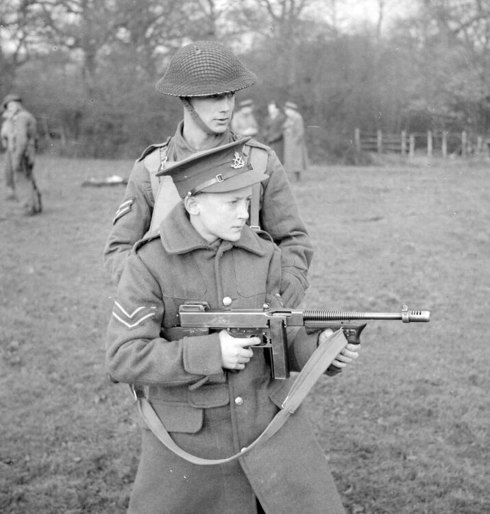 17 year-old Cecil Appleby from Queen Mary's School in Walsall learns to handle a Thompson SMG during a visit to a Junior Leaders school in the UK - January 8, 1942.jpg